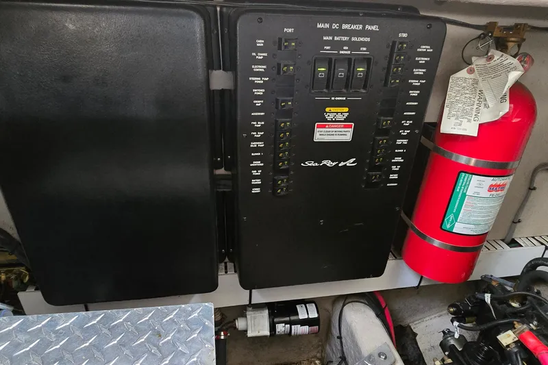 Slide: The Image of Main DC breaker panel and fire extinguisher on 2008 Sea Ray 38 Sundancer boat. - 44