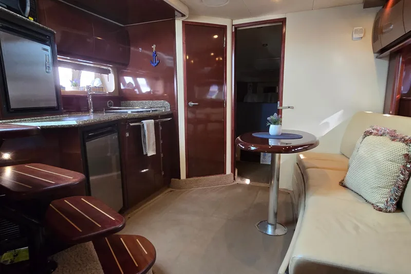 Slide: The Image of Interior of 2008 Sea Ray 38 Sundancer yacht with kitchenette and seating area. - 27
