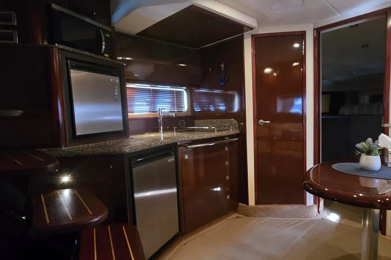 Slide: The Image of Luxurious 2008 Sea Ray 38 Sundancer yacht interior with modern kitchen and elegant wood finishes. - 22