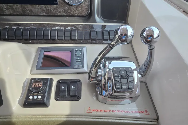 Slide: The Image of Control panel of a 2008 Sea Ray 38 Sundancer boat with throttle levers and navigation display. - 16
