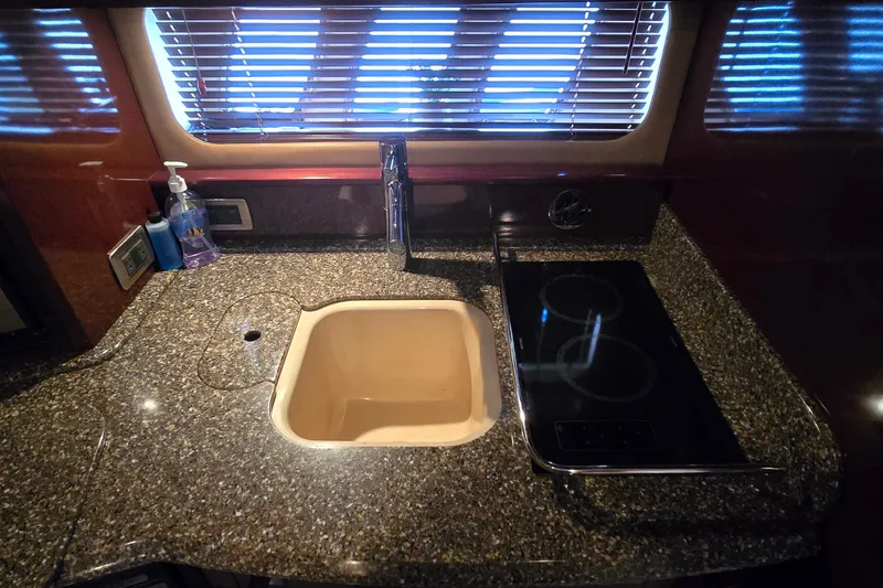 Slide: The Image of Luxurious 2008 Sea Ray 38 Sundancer galley with granite countertop, sink, and stove. - 23