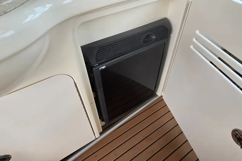 Slide: The Image of Mini fridge on 2008 Sea Ray 38 Sundancer yacht, with wooden flooring and white cabinetry. - 10