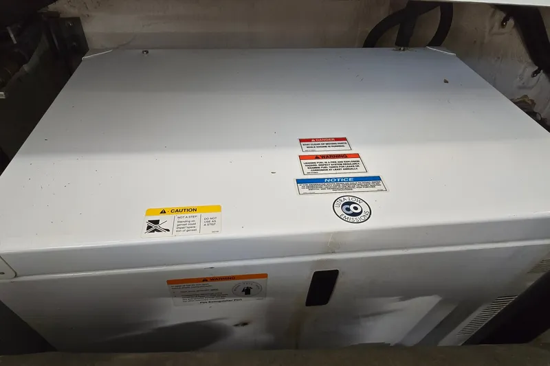 Slide: The Image of Engine compartment of a 2008 Sea Ray 38 Sundancer with caution labels visible. - 41