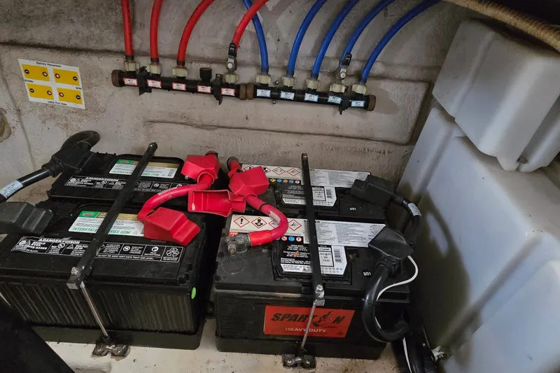 Slide: The Image of Battery compartment of a 2008 Sea Ray 38 Sundancer with wiring and connections. - 42