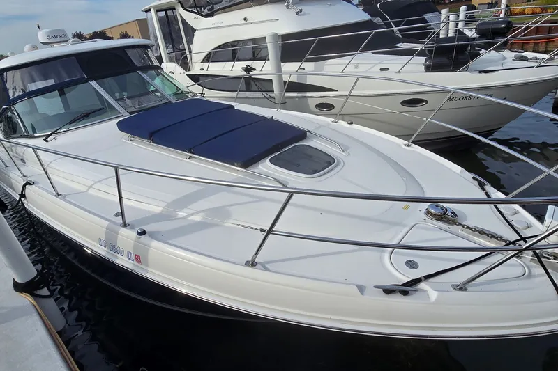 Slide: The Image of 2008 Sea Ray 38 Sundancer yacht docked, featuring sleek design and spacious deck. - 4
