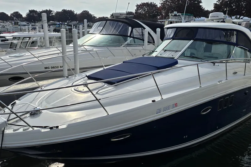 Slide: The Image of 2008 Sea Ray 38 Sundancer yacht docked at marina, sleek design, white and navy exterior. - 1