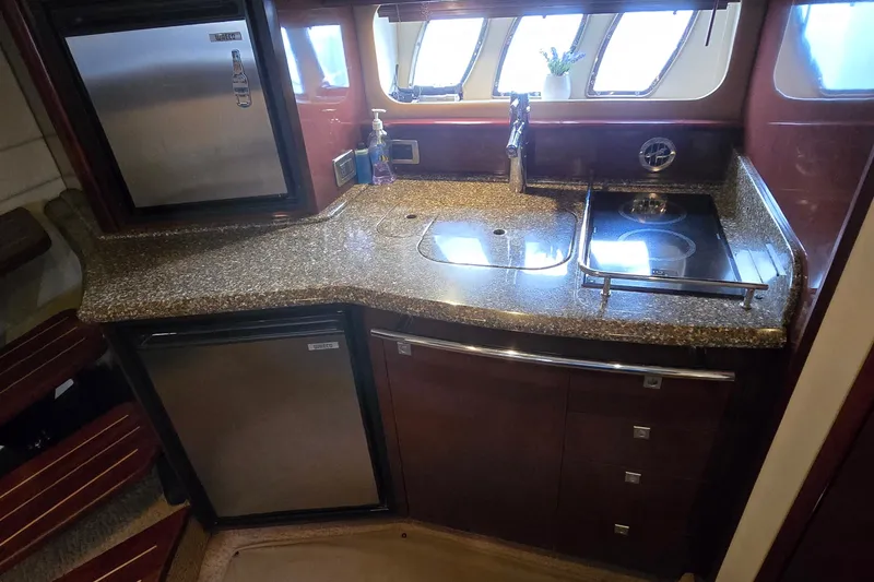 Slide: The Image of Luxurious 2008 Sea Ray 38 Sundancer yacht kitchen with granite countertops and modern appliances. - 24