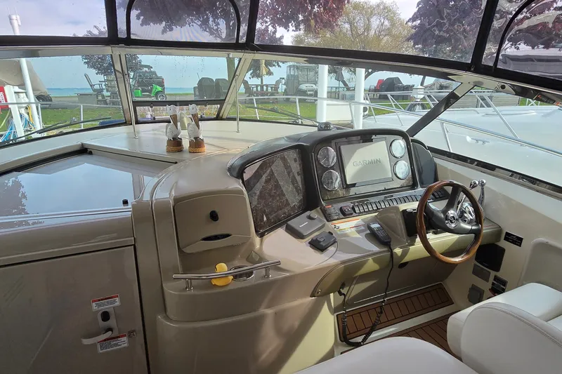 Slide: The Image of 2008 Sea Ray 38 Sundancer helm with Garmin navigation system and wooden steering wheel. - 12