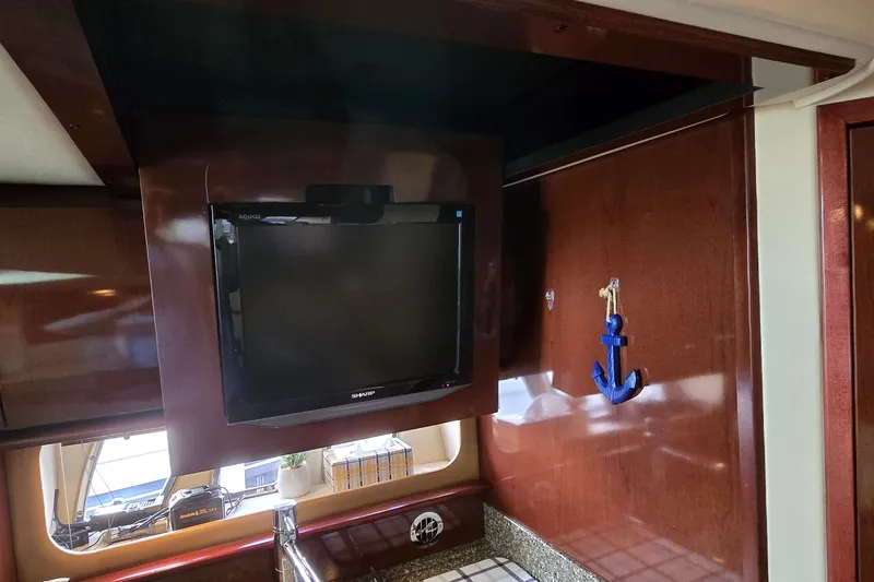 Slide: The Image of Interior of 2008 Sea Ray 38 Sundancer with TV and anchor decor. - 38
