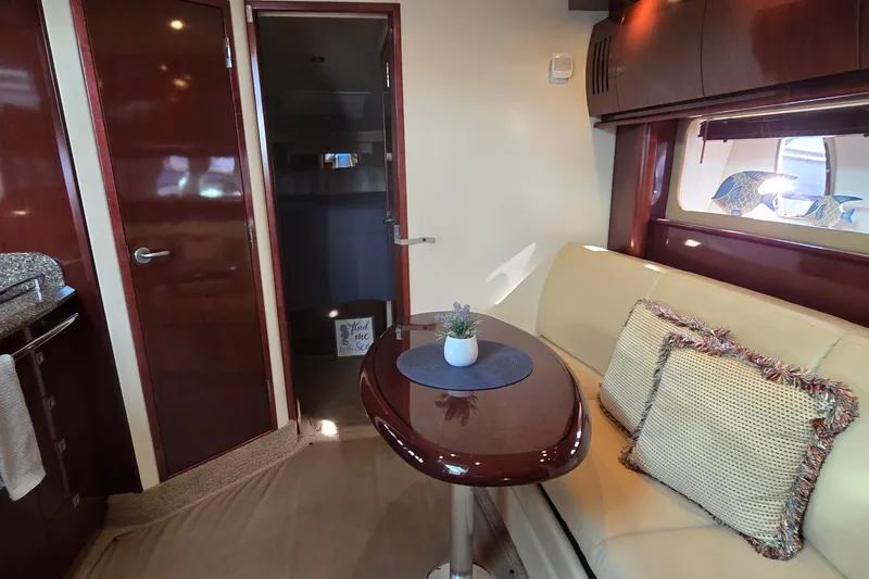 Slide: The Image of Interior of 2008 Sea Ray 38 Sundancer yacht with elegant seating and wooden finishes. - 29