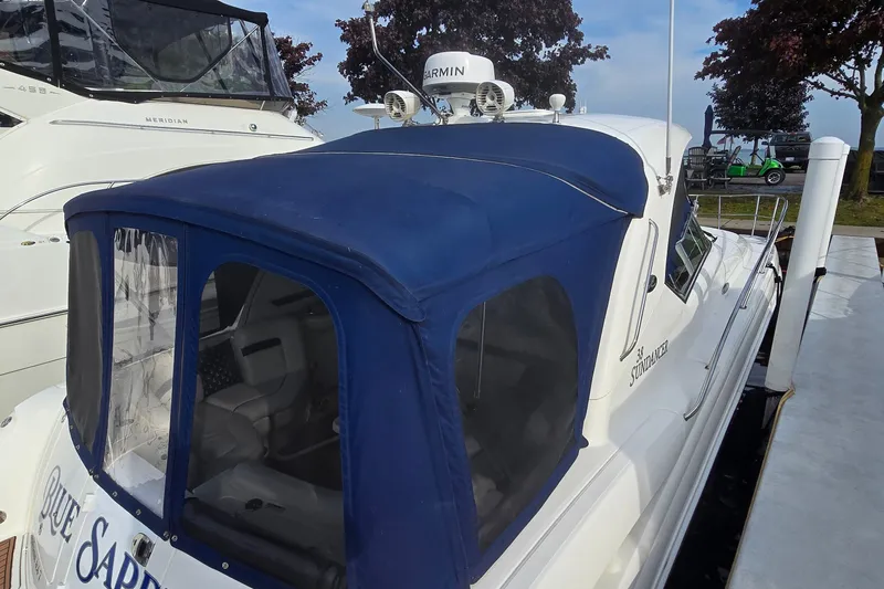 Slide: The Image of 2008 Sea Ray 38 Sundancer yacht with blue canopy docked at marina. - 3