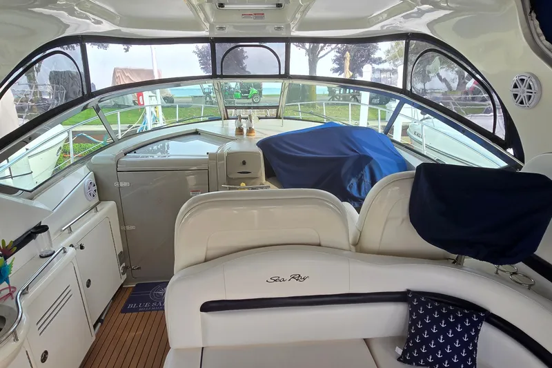 Slide: The Image of Interior view of a 2008 Sea Ray 38 Sundancer yacht with seating and covered controls. - 8