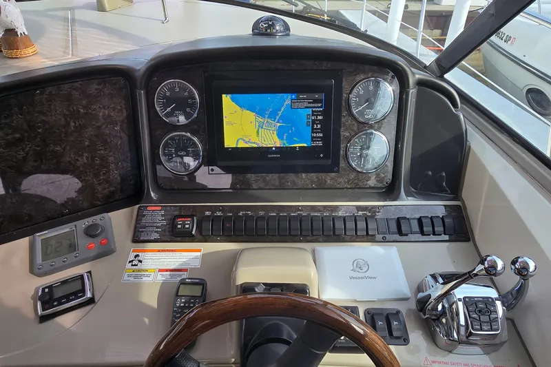 Slide: The Image of Helm of 2008 Sea Ray 38 Sundancer with navigation display and controls. - 14