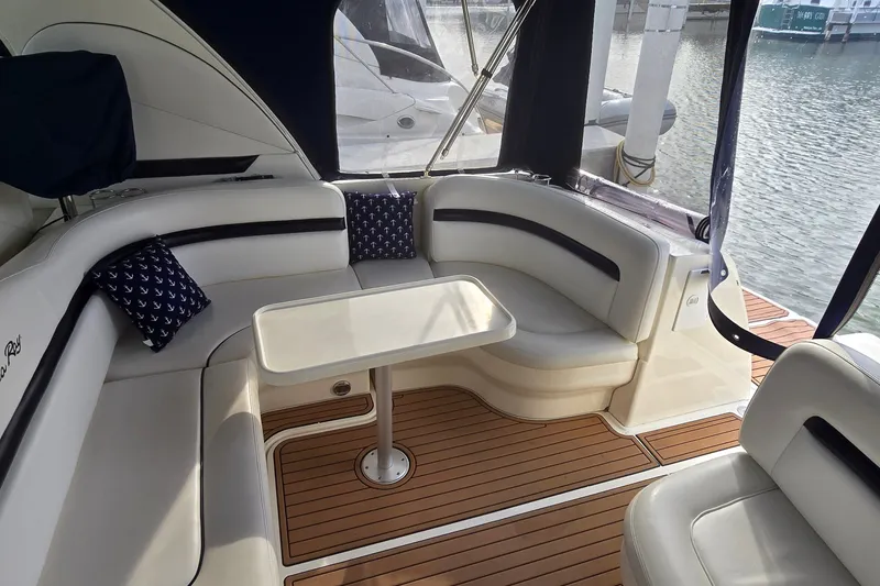 Slide: The Image of Luxurious 2008 Sea Ray 38 Sundancer yacht interior with elegant seating and table. - 6