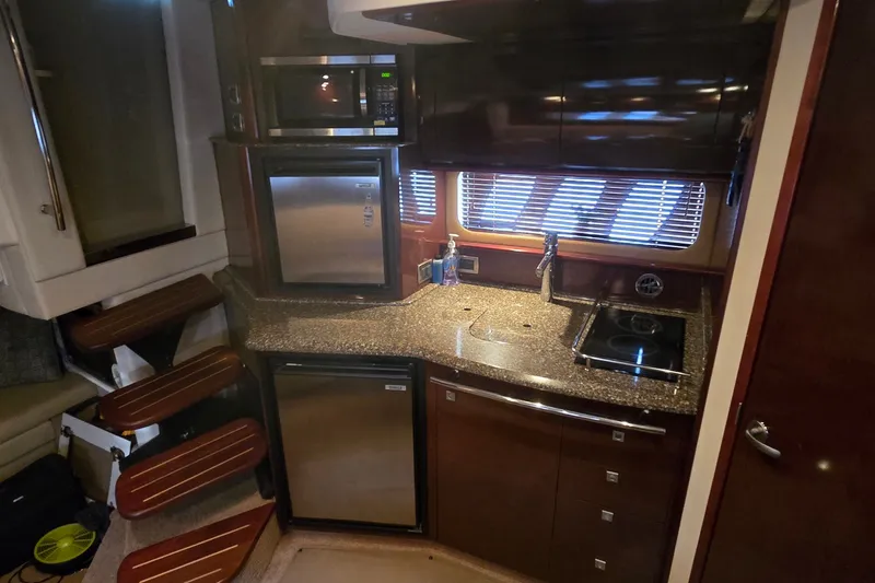 Slide: The Image of Luxurious 2008 Sea Ray 38 Sundancer yacht interior kitchen with modern appliances and sleek design. - 21