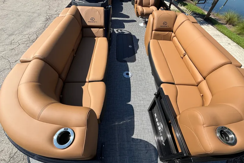 Slide: The Image of Luxurious seating on 2027 Regency 230 DL3 pontoon boat with tan upholstery and cup holders. - 5