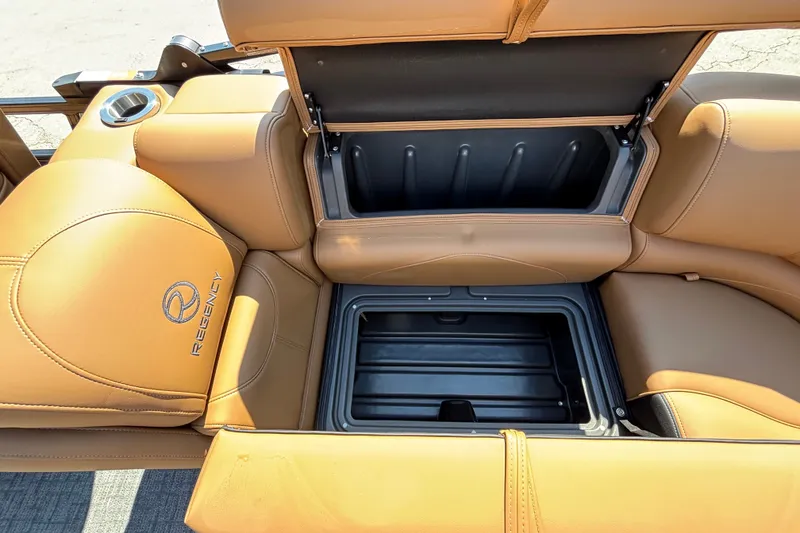 Slide: The Image of Luxurious tan leather seating with storage compartment in 2027 Regency 230 DL3 boat. - 11