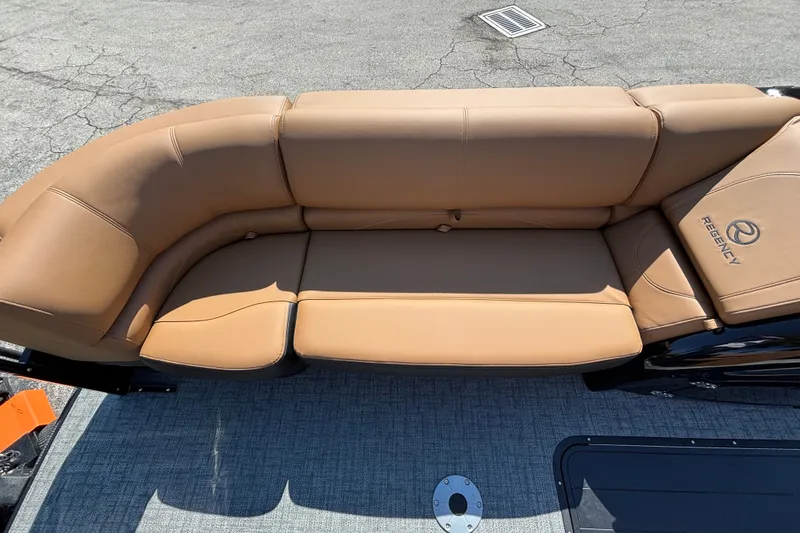 Slide: The Image of Luxurious tan seating on 2027 Regency 230 DL3 boat, showcasing comfort and style. - 6