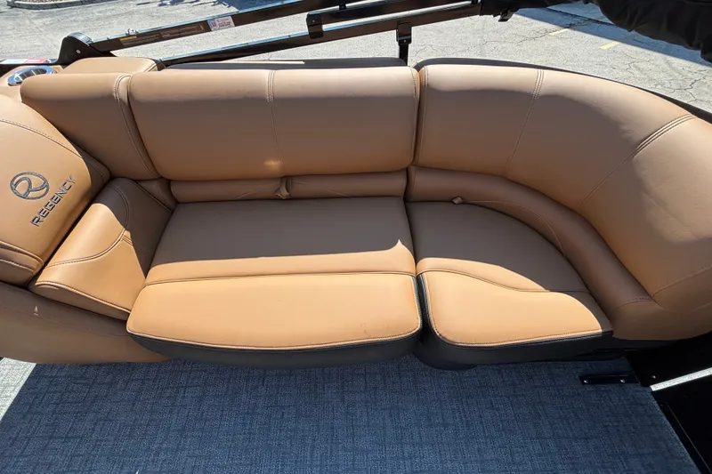 Slide: The Image of Luxurious tan seating on 2027 Regency 230 DL3 boat, showcasing comfort and style. - 12