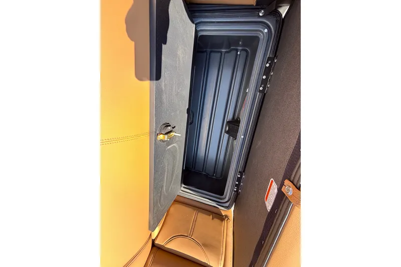Slide: The Image of Open storage compartment in 2027 Regency 230 DL3 boat, featuring sleek design and secure lock. - 18