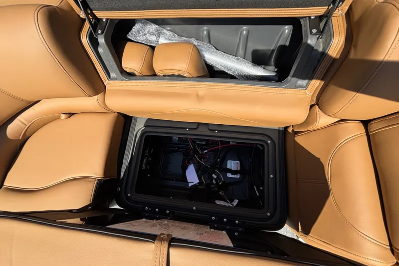 Slide: The Image of Tan leather seating with open storage compartments in a 2027 Regency 230 DL3 boat. - 14