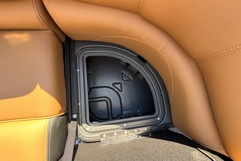 Slide: The Image of Storage compartment in 2027 Regency 230 DL3 boat with tan leather seating. - 13