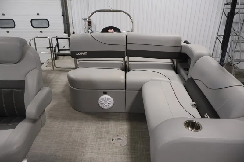 Slide: The Image of 2021 Lowe SS 210 CL pontoon boat interior with gray seating and cup holders. - 26