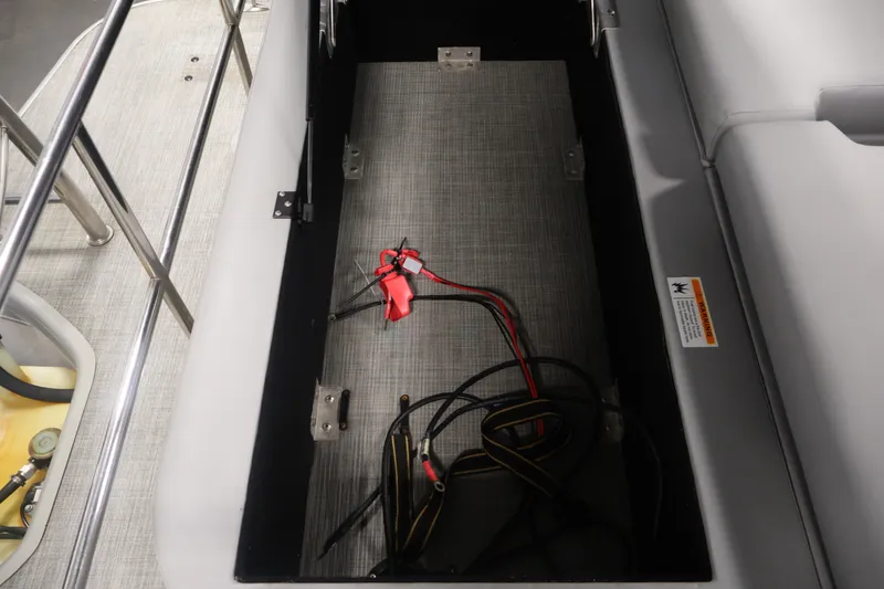 Slide: The Image of Open storage compartment with cables in a 2021 Lowe SS 210 CL boat. - 31