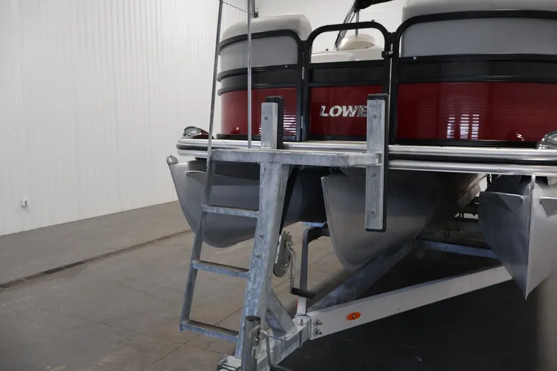 Slide: The Image of 2021 Lowe SS 210 CL pontoon boat on trailer in indoor storage. - 38