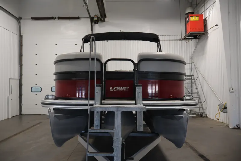 Slide: The Image of 2021 Lowe SS 210 CL pontoon boat in indoor storage facility. - 2