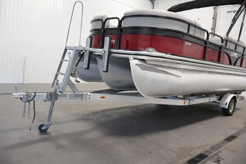 Slide: The Image of 2021 Lowe SS 210 CL pontoon boat on trailer in indoor storage. - 39