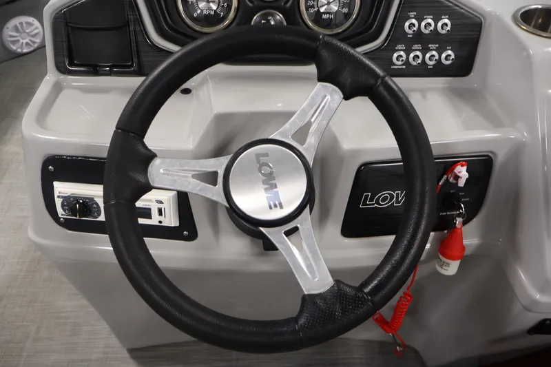 Slide: The Image of Steering wheel of a 2021 Lowe SS 210 CL boat with control panel and gauges. - 19