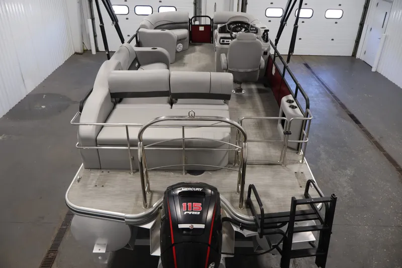 Slide: The Image of 2021 Lowe SS 210 CL pontoon boat with Mercury 115 Pro XS engine in a garage. - 9