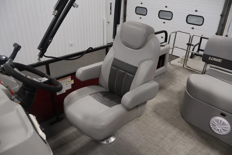 Slide: The Image of 2021 Lowe SS 210 CL boat interior with steering wheel and comfortable seating. - 25