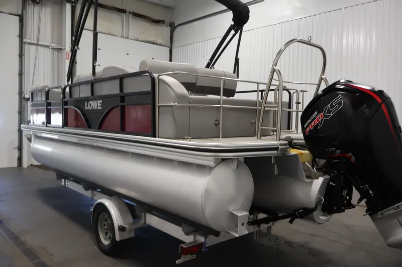 Slide: The Image of 2021 Lowe SS 210 CL pontoon boat with Mercury Pro XS engine in a garage. - 7