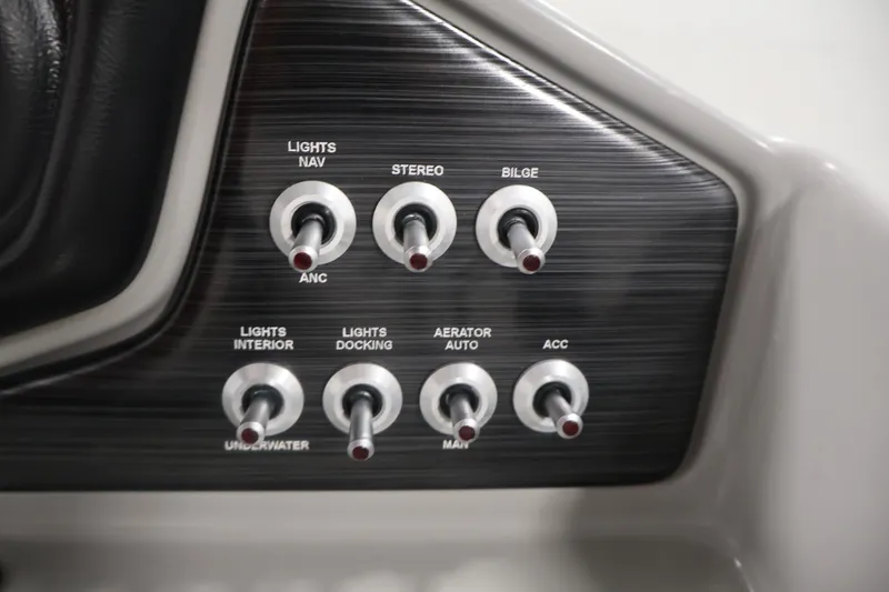 Slide: The Image of Control panel of a 2021 Lowe SS 210 CL boat with various switches. - 22