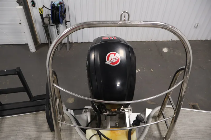 Slide: The Image of 2021 Lowe SS 210 CL boat motor with protective railing in a garage setting. - 32