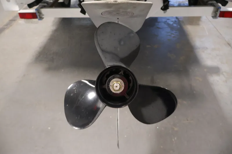 Slide: The Image of Close-up of a 2021 Lowe SS 210 CL boat propeller in a garage setting. - 35
