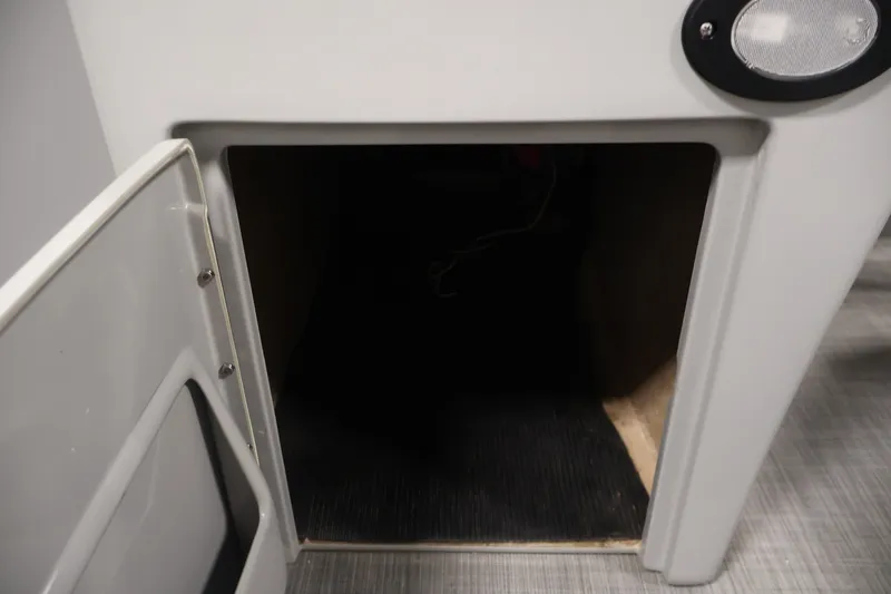 Slide: The Image of Open storage compartment on a 2021 Lowe SS 210 CL boat interior. - 17