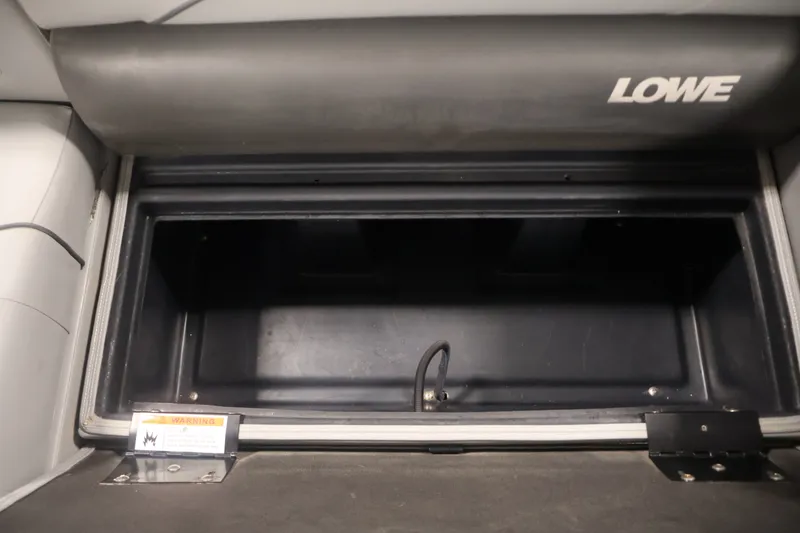 Slide: The Image of Storage compartment of a 2021 Lowe SS 210 CL boat, featuring ample space and secure design. - 27