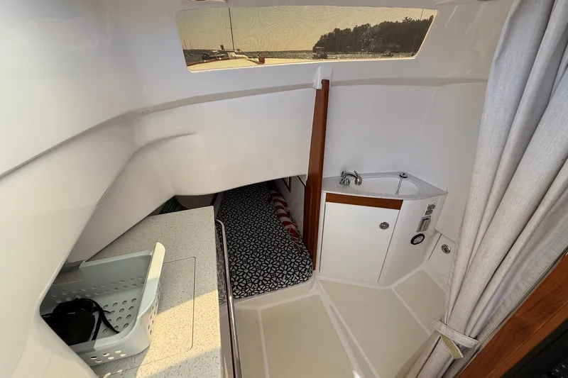 Slide: The Image of Interior of a 2018 Hunt 32cc boat with compact cabin and sink. - 36