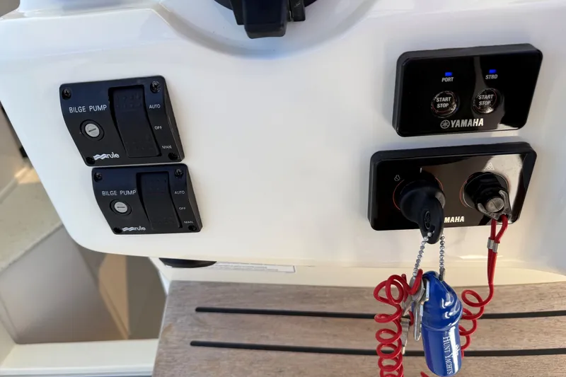 Slide: The Image of Control panel of a 2018 Hunt 32cc boat with Yamaha ignition and bilge pump switches. - 13