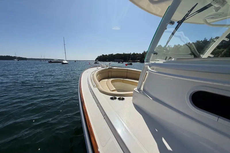 Slide: The Image of 2018 Hunt 32cc boat on calm water, featuring sleek design and spacious seating. - 29