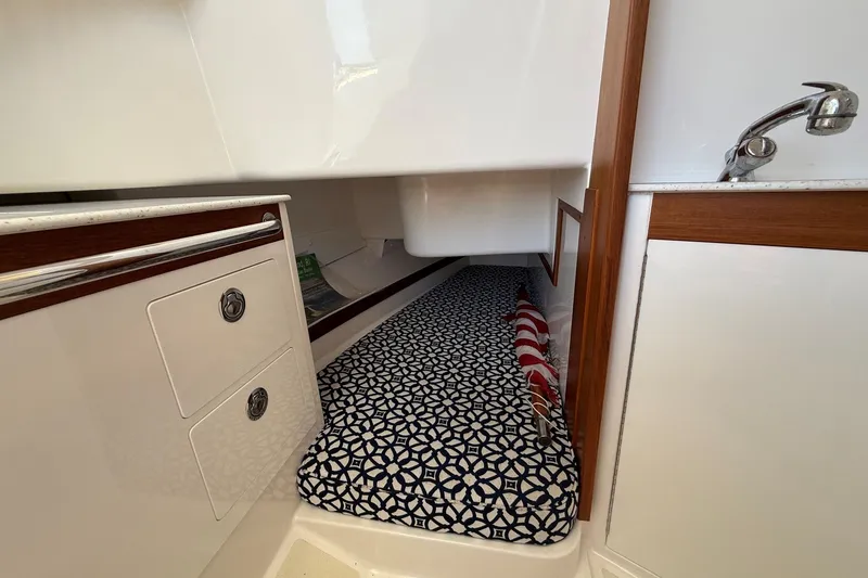 Slide: The Image of Interior cabin of 2018 Hunt 32cc boat with patterned bedding and compact storage. - 37