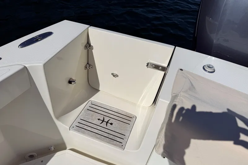 Slide: The Image of 2018 Hunt 32cc boat deck with storage compartment and marine fittings. - 23