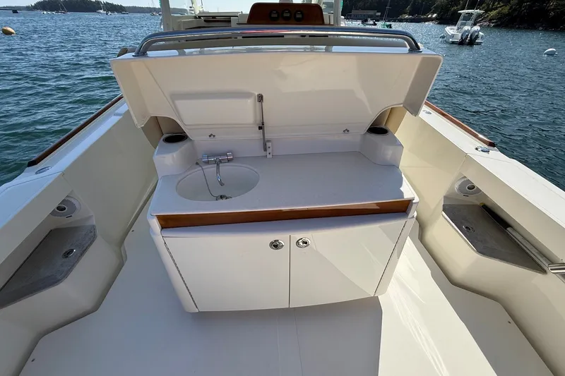 Slide: The Image of Boat interior with sink and storage on a 2018 Hunt 32cc, docked by the water. - 21