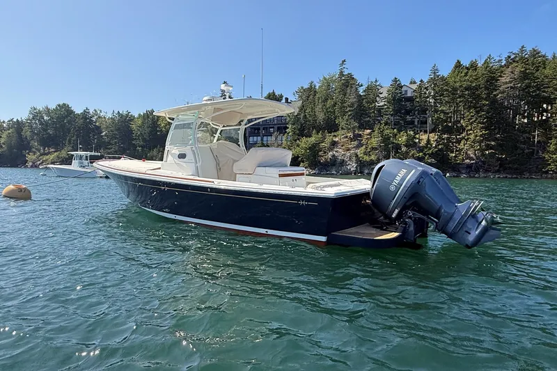 Slide: The Image of 2018 Hunt 32cc boat with Yamaha outboard motor on scenic water. - 2