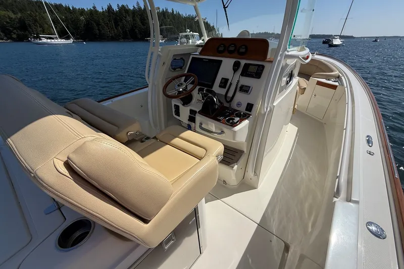 Slide: The Image of Interior of a 2018 Hunt 32cc boat with beige seating and control panel. - 7