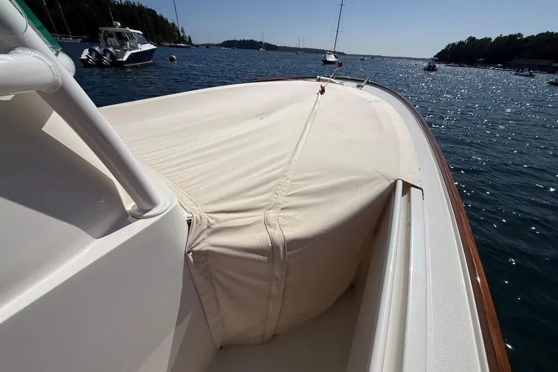 Slide: The Image of 2018 Hunt 32cc boat with covered deck, moored in a scenic harbor. - 34