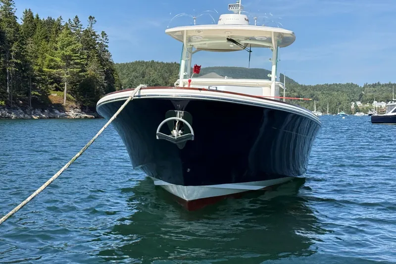 Slide: The Image of 2018 Hunt 32cc boat anchored in scenic lake with forested shoreline. - 5